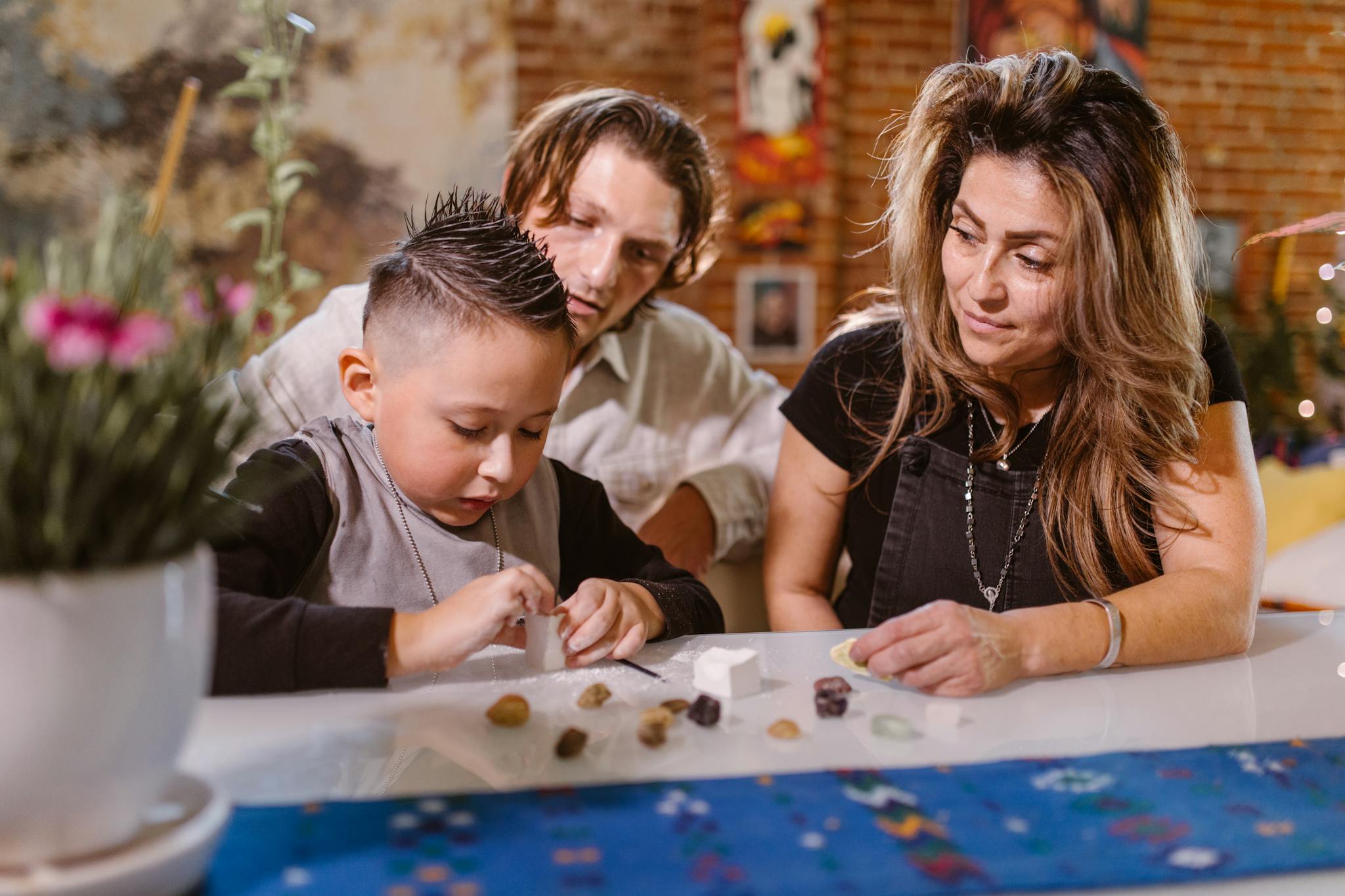 A family enjoys quality time crafting together indoors, fostering creativity and togetherness.